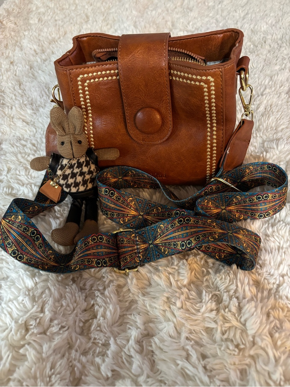Tan Leather Crossbody Bag with Decorative Stud Trim and Patterned Strap